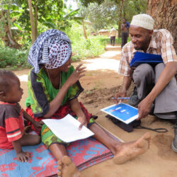 Child, woman, and man participating in school survey in Zanzibar